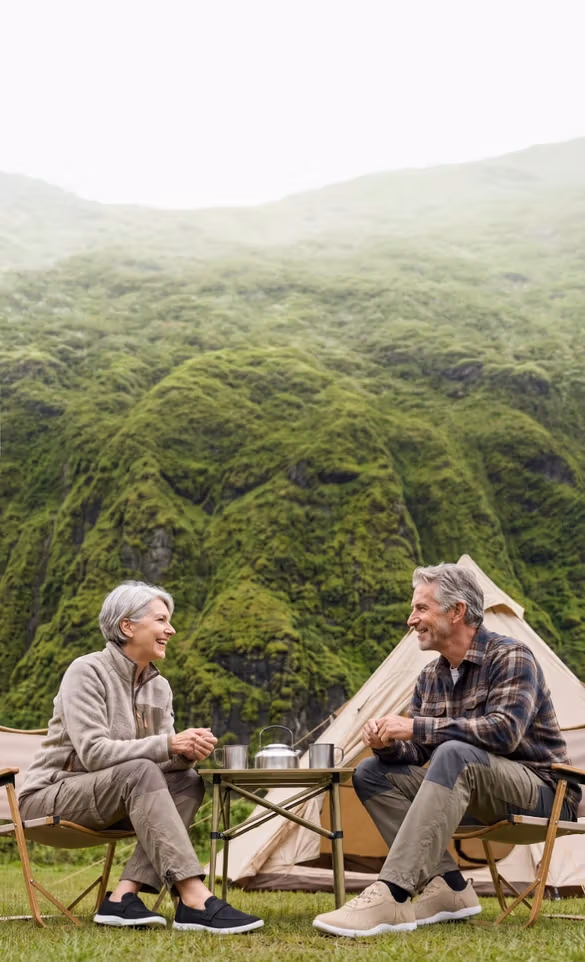Smiling couple enjoying the outdoors while wearing Pluma Footwear shoes